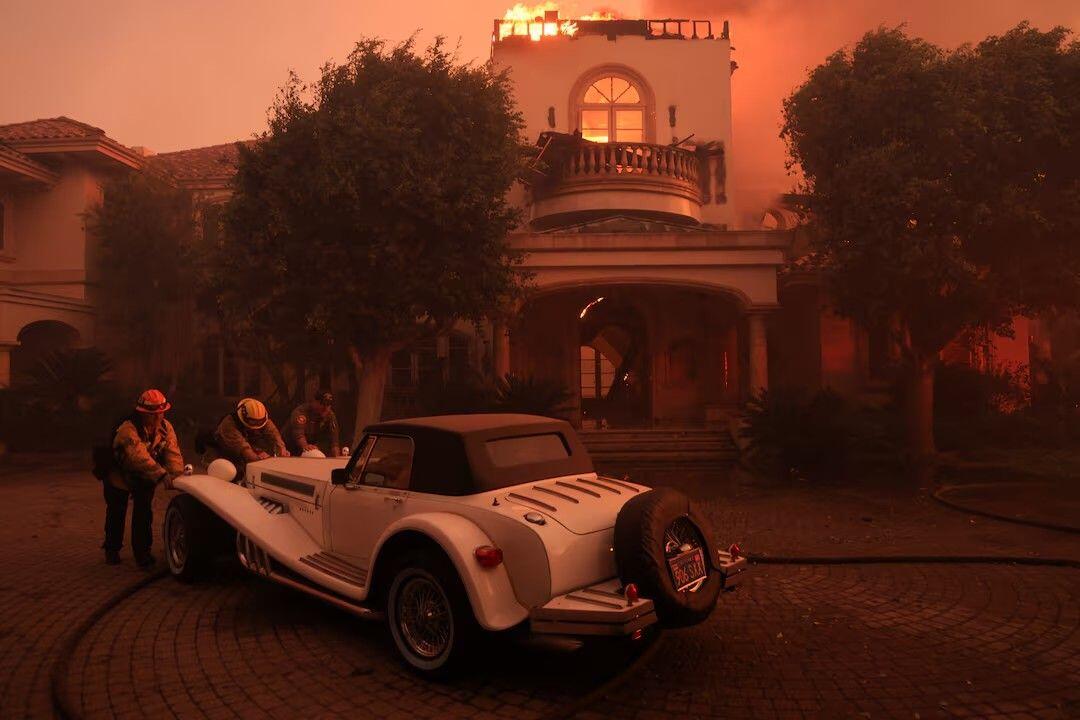 Rescue workers push a vintage car…