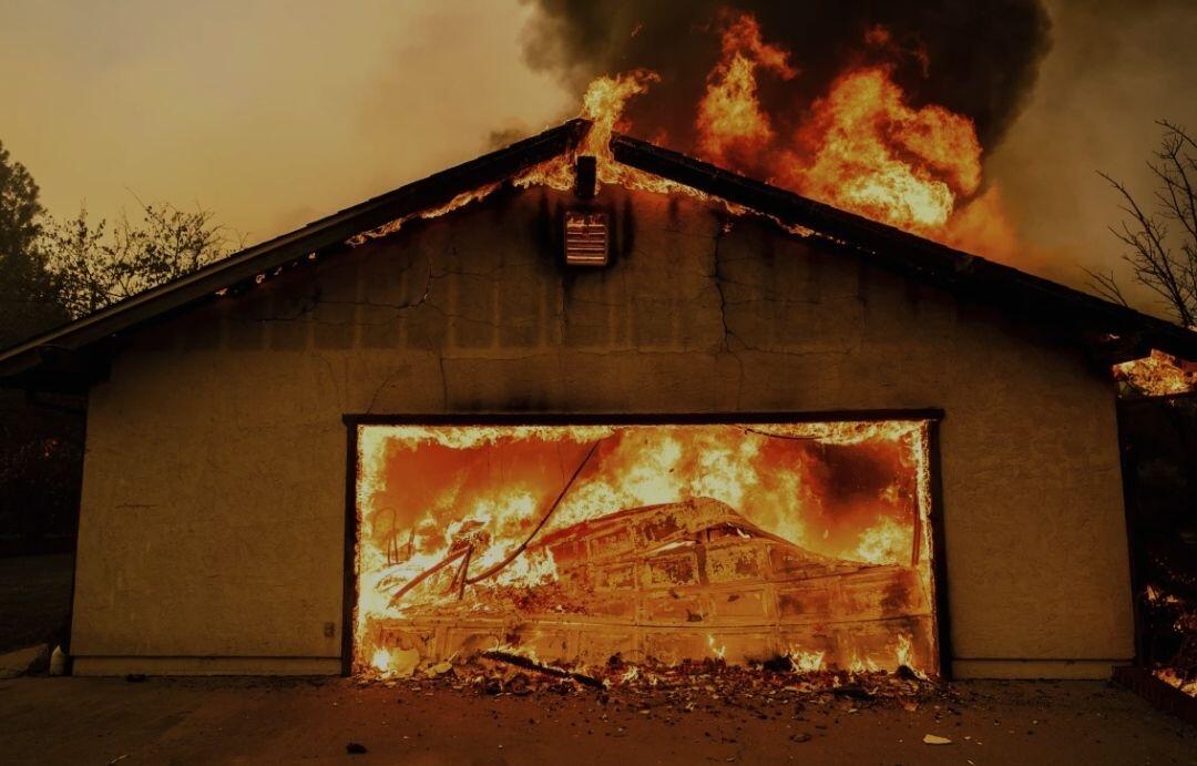 Flames consume a garage as the…