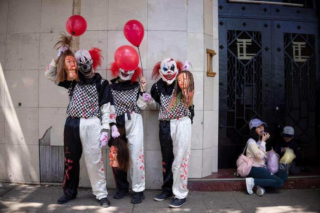 Participants dressed as zombie clowns take…