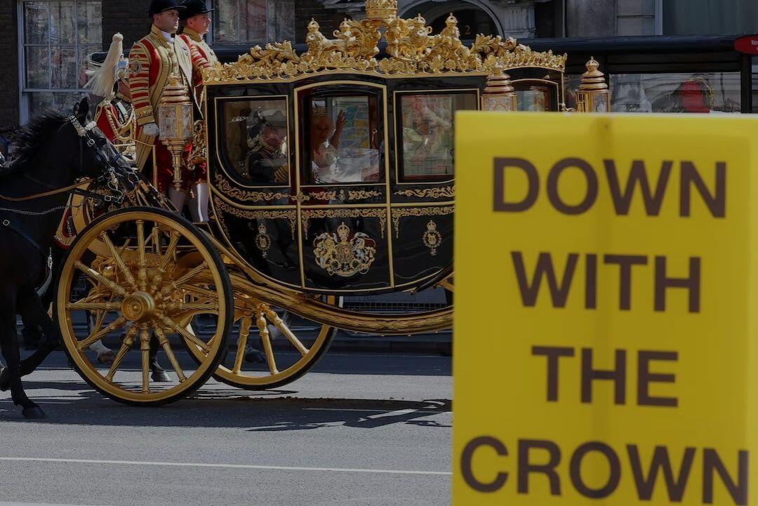 An anti-royal placard is held…