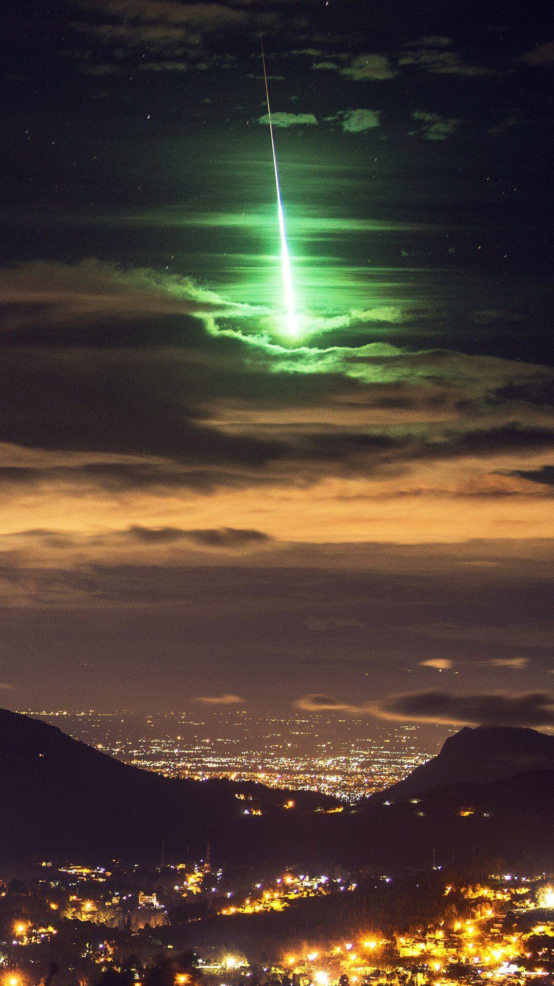A brilliant green meteor lights up…