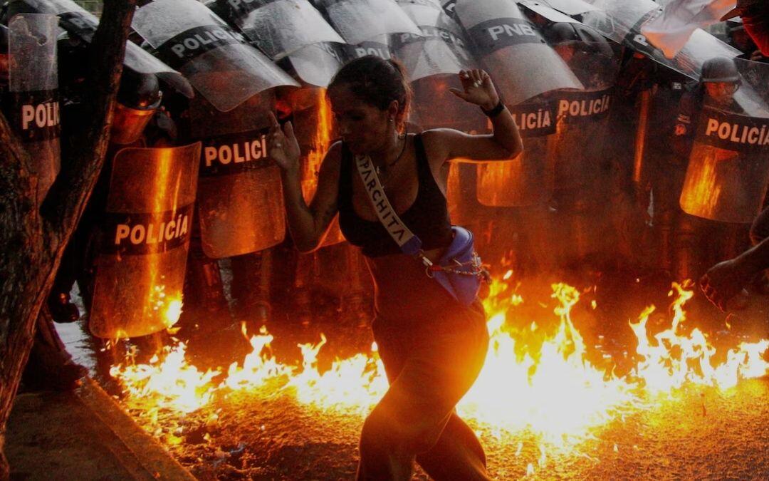 A demonstrator reacts when Molotov cocktails…