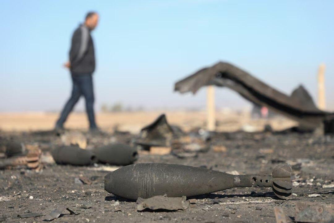 A man walks amid the damage,…