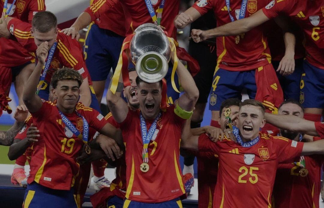 Spain's Alvaro Morata holds the…