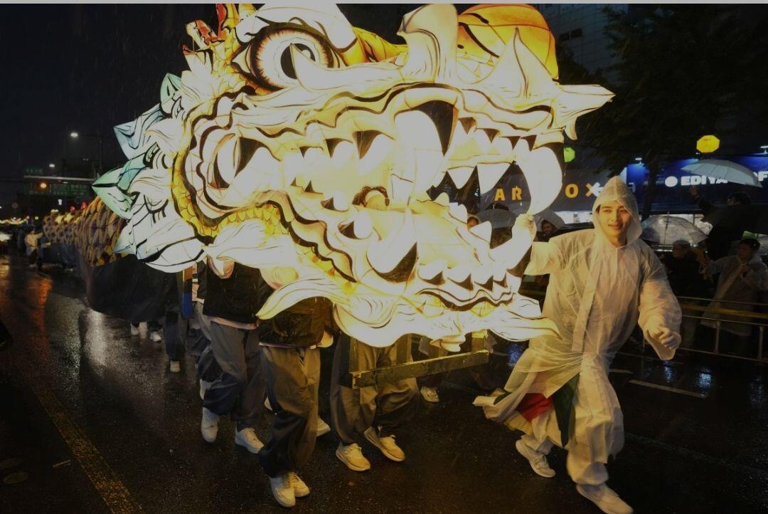 Buddhists walk with a giant lantern…