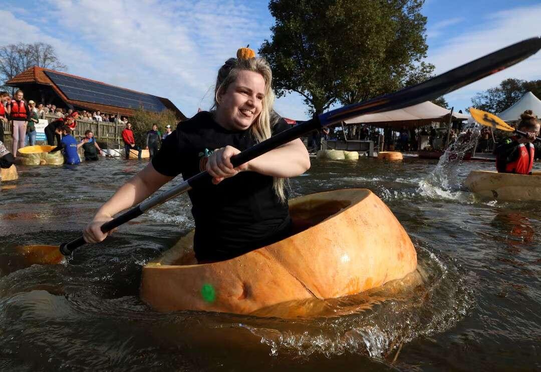 Competitors paddle in giant hollowed out…