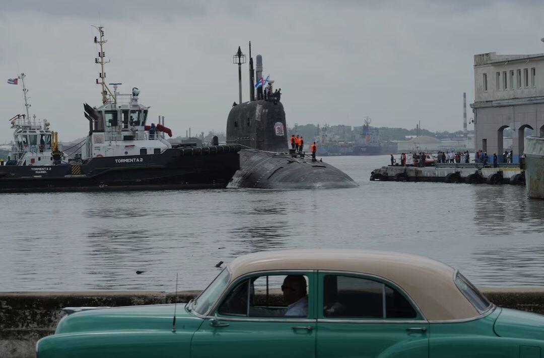 A vintage car passes by as…