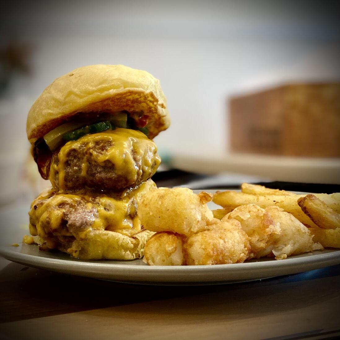 A photo of a hamburger using the buns, along with fries