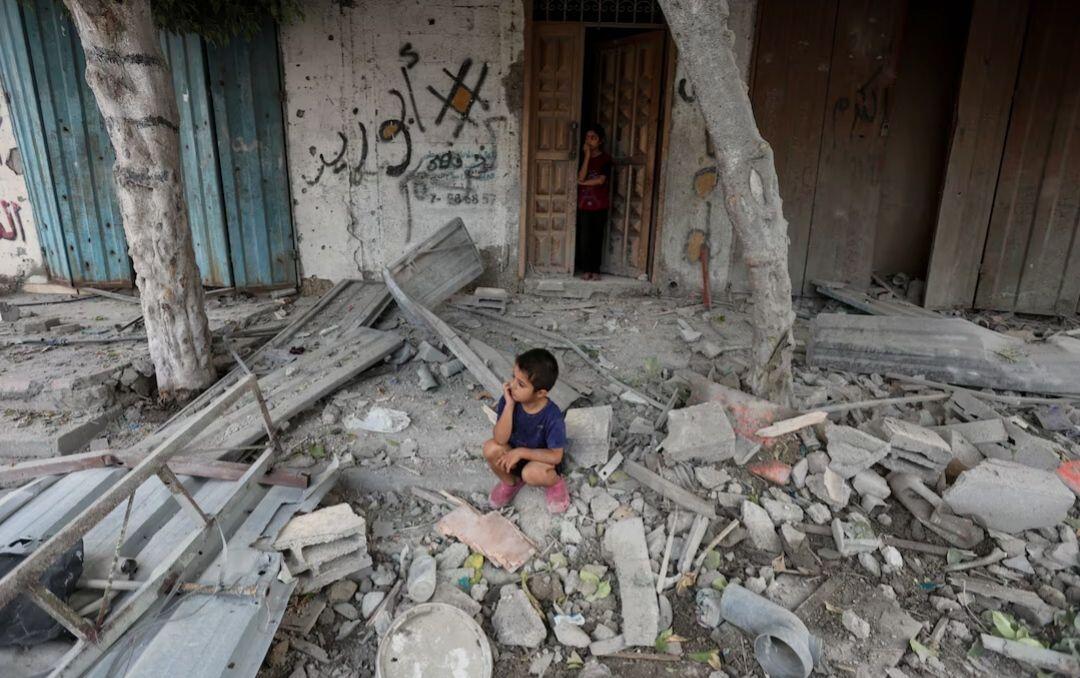 A Palestinian boy sits at the…