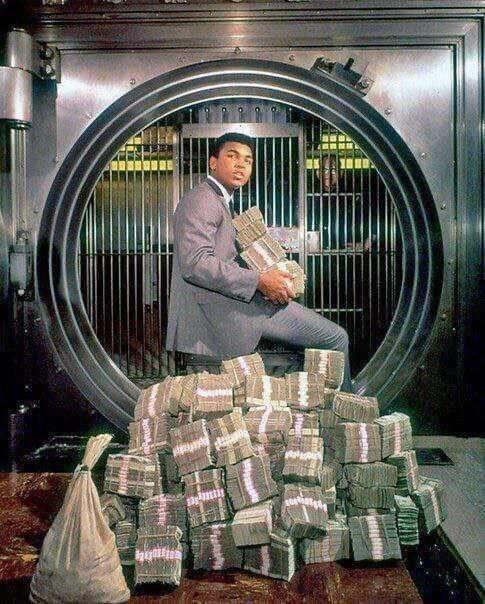 Muhammad Ali picks up his winnings,…