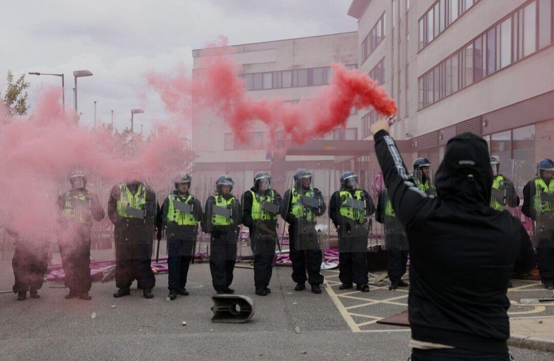 A protester holds a smoke flare…