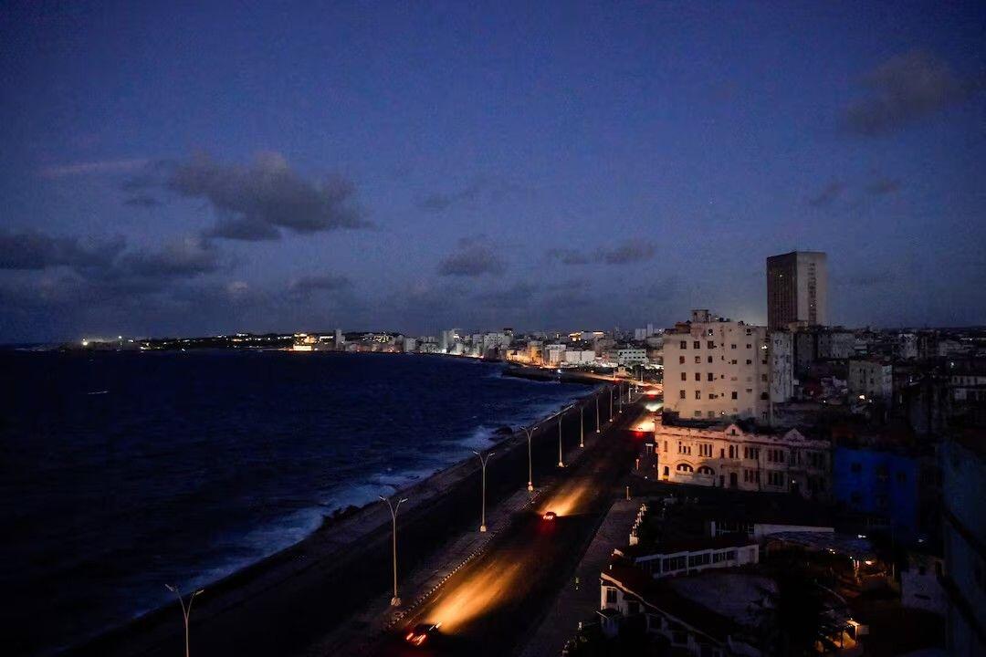 Cars drive on Havana's seafront…