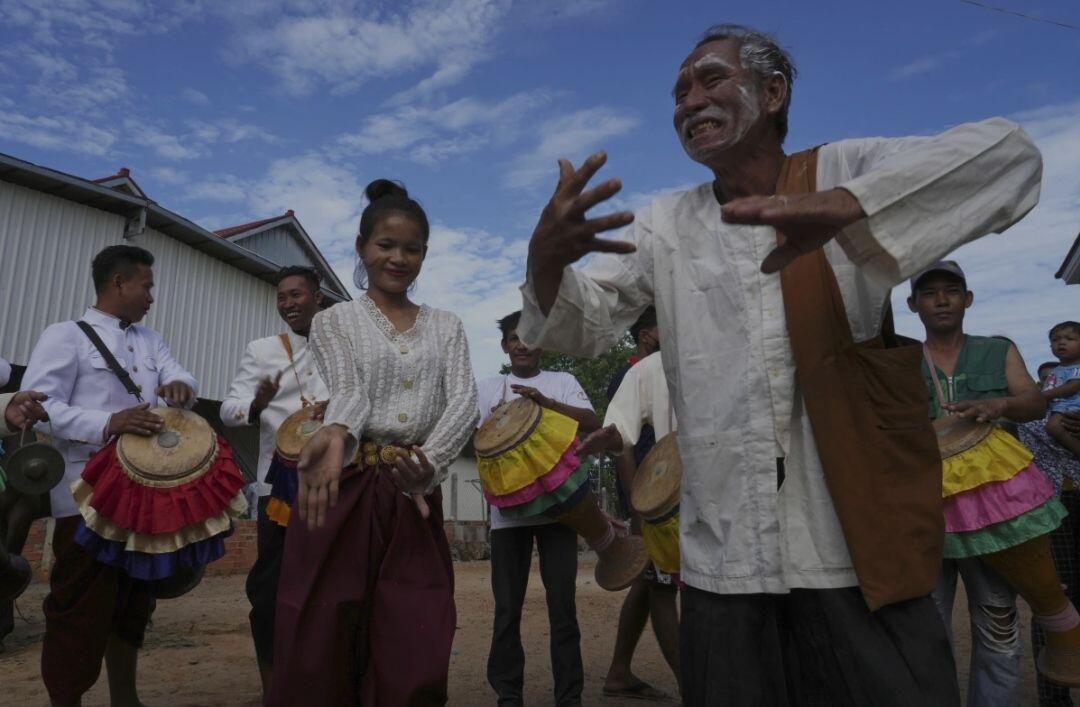 An elderly man joins dancers participating…